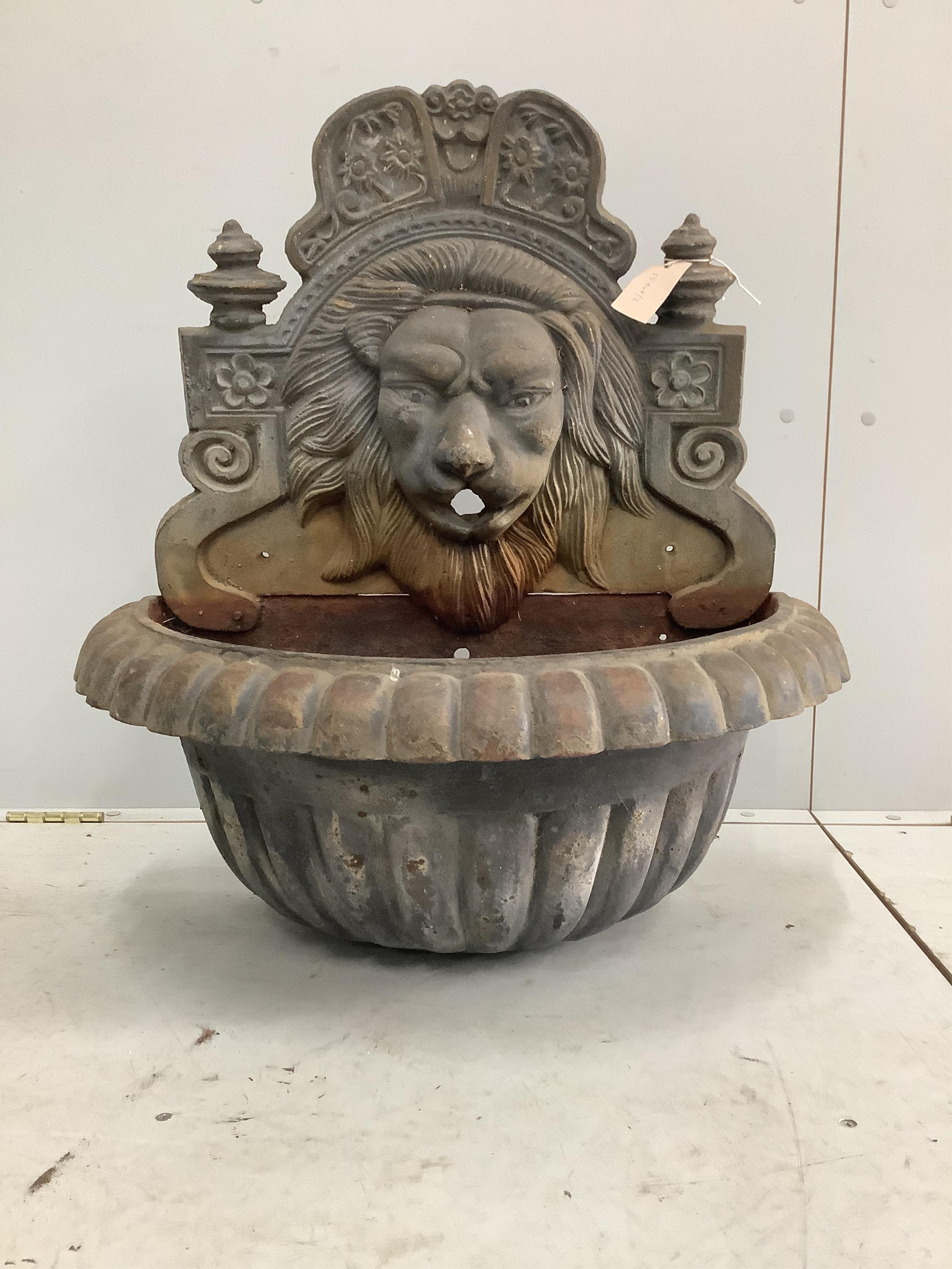 A cast iron lion mask wall fountain, width 68cm, height 74cm. Condition - fair